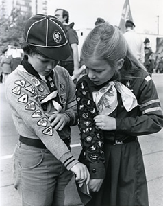 Scout and Brownie looking at uniform badges